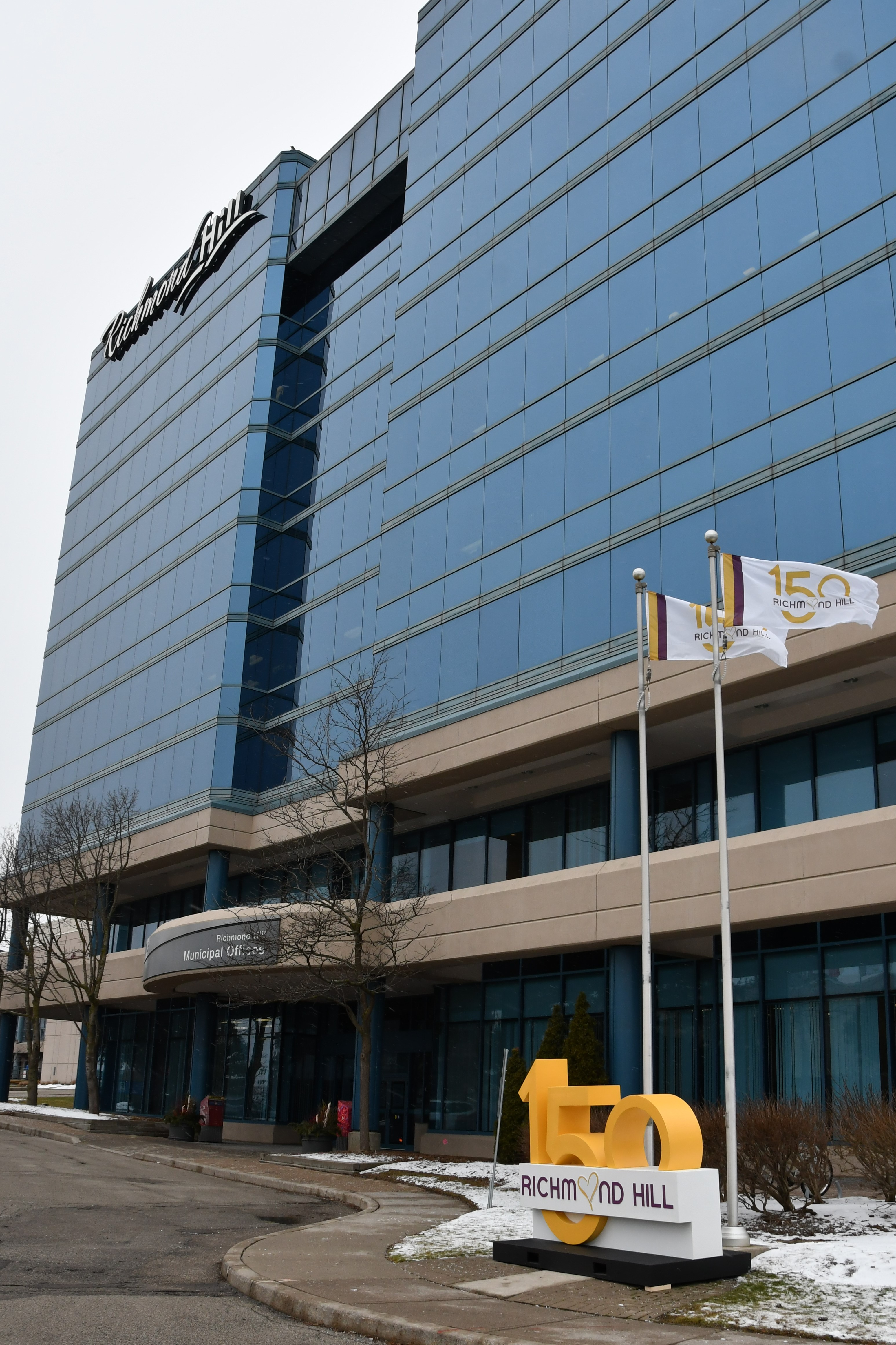 New Richmond Hill 150 flag flying in front of municipal office